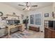 Home office featuring dual monitors, a ceiling fan, and shuttered windows at 3059 E Tyson Ct, Gilbert, AZ 85295