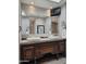 Elegant bathroom featuring a double sink vanity, custom tiling, and a mounted TV at 3137 N 4Th Ave, Phoenix, AZ 85013
