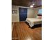 Bedroom showcasing hardwood floors, barn door, and cozy decor at 3137 N 4Th Ave, Phoenix, AZ 85013