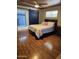 Bedroom featuring hardwood floors, barn door, and bright natural light from a window at 3137 N 4Th Ave, Phoenix, AZ 85013