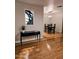 Open-concept dining area with sleek black table and chairs, hardwood floors, and statement window at 3137 N 4Th Ave, Phoenix, AZ 85013