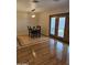 Dining area featuring double doors, hardwood floors, and modern chandelier lighting at 3137 N 4Th Ave, Phoenix, AZ 85013