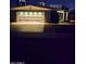 Inviting single-story home features a garage with stylish lighting, enhancing its curb appeal during nighttime at 3137 N 4Th Ave, Phoenix, AZ 85013