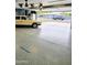 Well-lit garage featuring epoxy floors, fans, and a car, providing ample space and functionality at 3137 N 4Th Ave, Phoenix, AZ 85013
