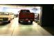 Organized garage featuring multiple vehicles, including a bright orange truck at 3137 N 4Th Ave, Phoenix, AZ 85013
