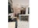 Well-lit kitchen featuring a dining bar, modern appliances, and tiled flooring at 3137 N 4Th Ave, Phoenix, AZ 85013