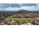 Expansive aerial view overlooking a golf course community with mountain views under a cloudy sky at 3521 N Barron --, Mesa, AZ 85207