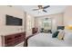Cozy bedroom featuring a large TV, a bay window with a desk, and warm, inviting decor at 3521 N Barron --, Mesa, AZ 85207