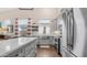 Modern kitchen featuring stainless appliances, an island with a white countertop, and a window overlooking the yard at 3521 N Barron --, Mesa, AZ 85207