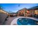 Inviting backyard featuring a covered patio, outdoor kitchen, cozy seating around a fire pit and a sparkling pool at 3521 N Barron --, Mesa, AZ 85207