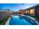 A backyard pool area featuring a refreshing pool, an outdoor kitchen, cozy seating around a fire pit and a covered patio at 3521 N Barron --, Mesa, AZ 85207