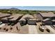 Aerial view of home with desert landscaping, a golf course, and mountain views at 3565 E Meadowview Dr, Gilbert, AZ 85298