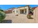Charming backyard featuring a covered patio, gravel landscaping, and colorful flowers at 3565 E Meadowview Dr, Gilbert, AZ 85298