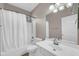 Bright bathroom showcasing a tub/shower combo, a white vanity, and tile floors at 3565 E Meadowview Dr, Gilbert, AZ 85298