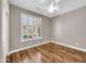 Bedroom with wood floors, modern fan, and shutters offers a bright space at 3565 E Meadowview Dr, Gilbert, AZ 85298