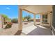 Covered patio with view of gravel landscaping, flowering bushes and iron fence at 3565 E Meadowview Dr, Gilbert, AZ 85298