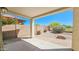 A covered patio looks out onto a gravel landscape with a brick wall surround at 3565 E Meadowview Dr, Gilbert, AZ 85298