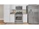 Kitchen featuring stainless steel appliances, granite countertops, and white cabinets at 3565 E Meadowview Dr, Gilbert, AZ 85298
