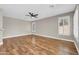 Spacious living room with wood floors, ceiling fan, and plantation shutters at 3565 E Meadowview Dr, Gilbert, AZ 85298