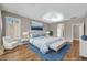 Staged main bedroom featuring a ceiling fan, furniture, and hardwood floors at 3565 E Meadowview Dr, Gilbert, AZ 85298