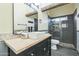 Bathroom with stone accents, modern vanity, stylish mirror, and glass enclosed shower at 4024 E Hiddenview Dr, Phoenix, AZ 85048