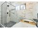 Modern bathroom with a large soaking tub, glass shower, and beautiful stone flooring at 4024 E Hiddenview Dr, Phoenix, AZ 85048