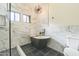 Bathroom with a marble tub, glass shower, and modern lighting at 4024 E Hiddenview Dr, Phoenix, AZ 85048
