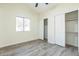 Bedroom showcasing wood-look flooring, closet and natural light from the window at 4024 E Hiddenview Dr, Phoenix, AZ 85048