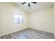 This bedroom has an updated ceiling fan, fresh paint, and wood-look flooring at 4024 E Hiddenview Dr, Phoenix, AZ 85048