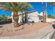 Charming front yard with desert landscaping and palm trees enhances curb appeal at 4024 E Hiddenview Dr, Phoenix, AZ 85048