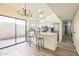 Open kitchen with bar stool seating, stainless steel appliances, and sliding glass doors at 4024 E Hiddenview Dr, Phoenix, AZ 85048