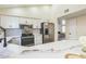 Kitchen with modern appliances, white cabinets, and eat-in marble countertop at 4024 E Hiddenview Dr, Phoenix, AZ 85048