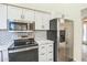 Modern kitchen with stainless steel appliances and white subway tile backsplash at 4024 E Hiddenview Dr, Phoenix, AZ 85048