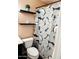 Modern bathroom with decorative shower curtain and floating shelves at 4213 W Villa Linda Dr, Glendale, AZ 85310