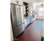 Bright kitchen features stainless steel appliances, a farm sink, and white cabinetry at 4213 W Villa Linda Dr, Glendale, AZ 85310