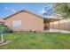 Home's backyard showing lawn, landscaping and a covered patio at 425 S 93Rd Pl, Mesa, AZ 85208