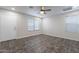 Bright bedroom with neutral walls, two windows, a ceiling fan, and tile flooring at 425 S 93Rd Pl, Mesa, AZ 85208
