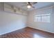 Charming bedroom with wood-look floors, ceiling fan, and built-in shelving at 425 S 93Rd Pl, Mesa, AZ 85208