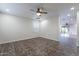Neutral bedroom with a ceiling fan, tile flooring, and a window for natural light at 425 S 93Rd Pl, Mesa, AZ 85208