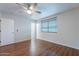 Spacious bedroom with modern ceiling fan, wood-look flooring and bright natural light at 425 S 93Rd Pl, Mesa, AZ 85208