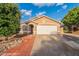 Charming single-story home with a two-car garage, desert landscaping, and a welcoming facade at 425 S 93Rd Pl, Mesa, AZ 85208