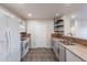 Well-lit kitchen featuring modern appliances, gray cabinets, and stylish tile backsplash at 425 S 93Rd Pl, Mesa, AZ 85208