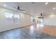 Open living space with tile and laminate floors, natural light, and a modern ceiling fan at 425 S 93Rd Pl, Mesa, AZ 85208
