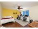 Bright bedroom featuring a king-size bed, hardwood floors, and two workstation desks with computers at 4431 N 21St Pl, Phoenix, AZ 85016