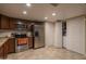 Bright kitchen with stainless steel appliances, tile floors, and direct access to laundry room and closet at 4431 N 21St Pl, Phoenix, AZ 85016
