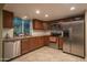 Well-lit kitchen featuring stainless steel appliances, granite counters, tile floors and wood cabinets at 4431 N 21St Pl, Phoenix, AZ 85016