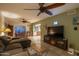 Inviting living room featuring stylish decor, tile flooring, a ceiling fan and seamless flow into dining and kitchen at 4431 N 21St Pl, Phoenix, AZ 85016