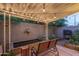 Cozy covered patio featuring string lights, a serene pond and comfortable seating for outdoor enjoyment at 4431 N 21St Pl, Phoenix, AZ 85016