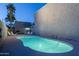 Outdoor swimming pool with illuminated water and surrounded by lounge chairs and palm trees at twilight at 4431 N 21St Pl, Phoenix, AZ 85016