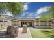 A well-maintained backyard with artificial turf, a covered patio, and decorative stone pillars, ideal for relaxation and outdoor enjoyment at 4512 W Rushmore Dr, Anthem, AZ 85087